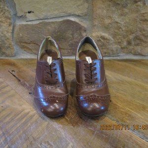 Brown leather lace up saddle leather heels.